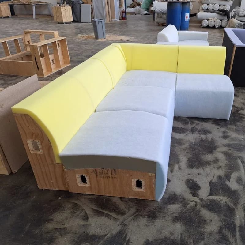 A Scooch sofa in the factory before upholstering, showing the layers of foam.