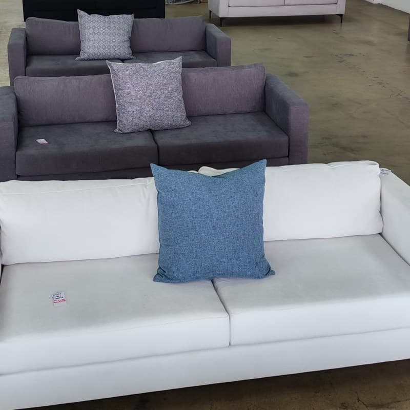 Row of 2-seater sofas in the factory showroom.