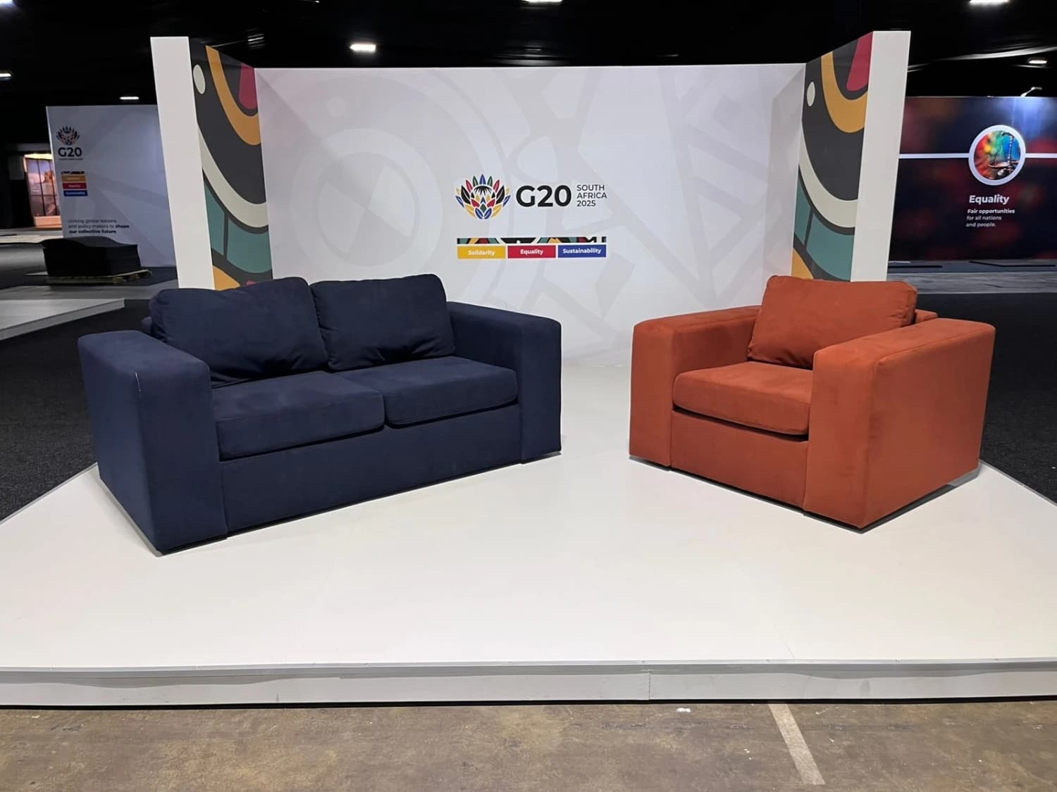 A blue Scooch sofa and a red Scooch armchair sit on a plinth at the G20 Summit in Cape Town